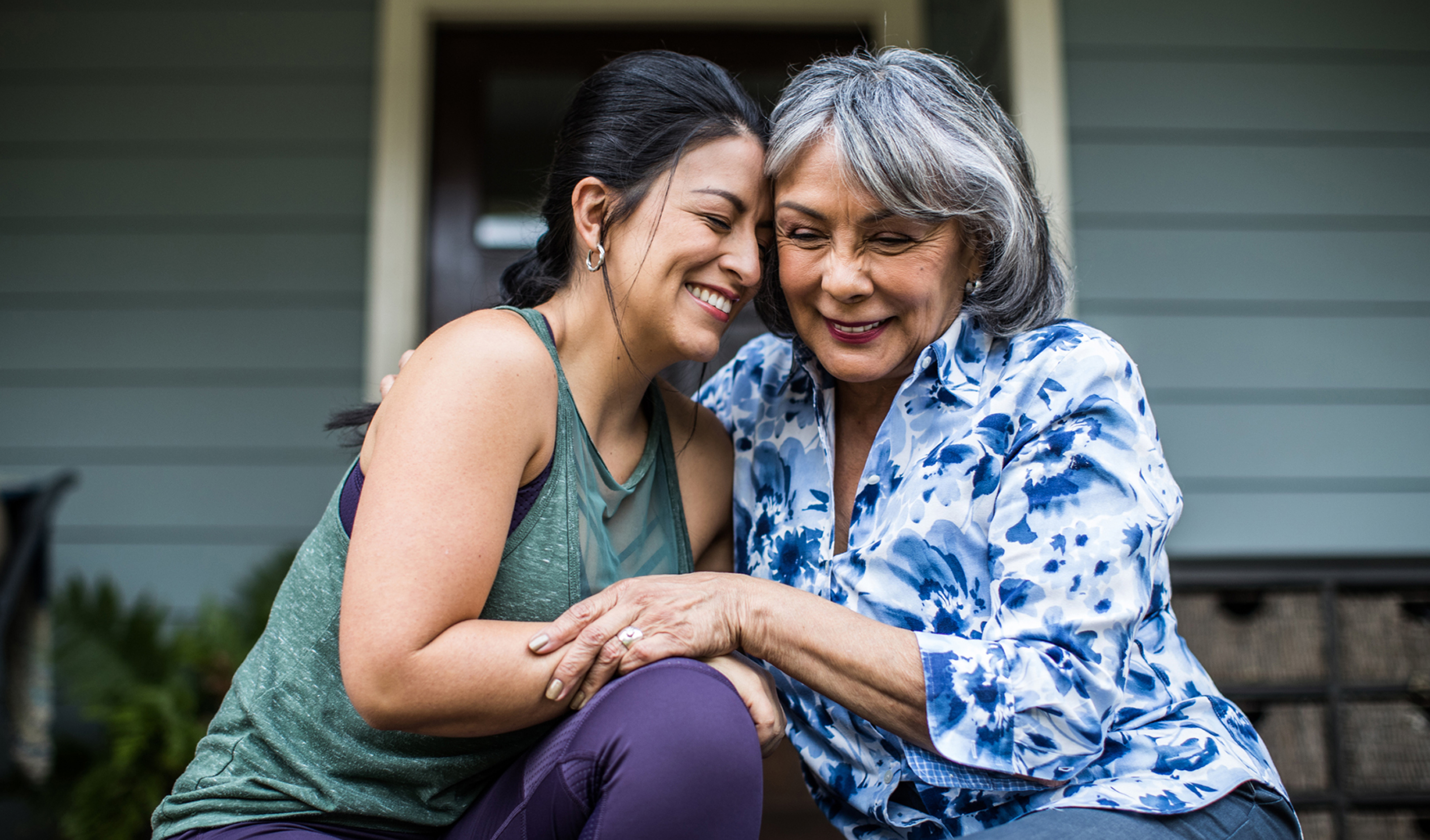 two women hugging and laughing