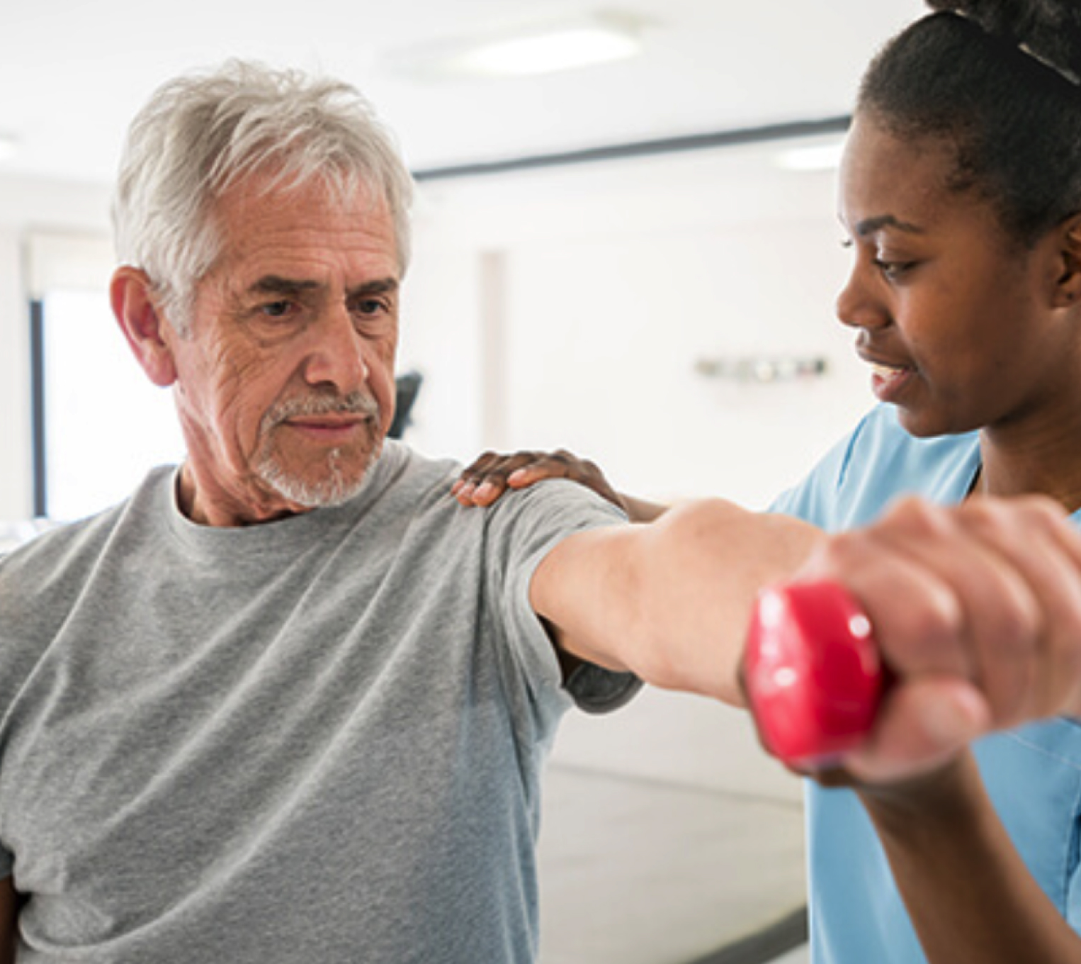 man lifting a dumbbell. a woman helping him